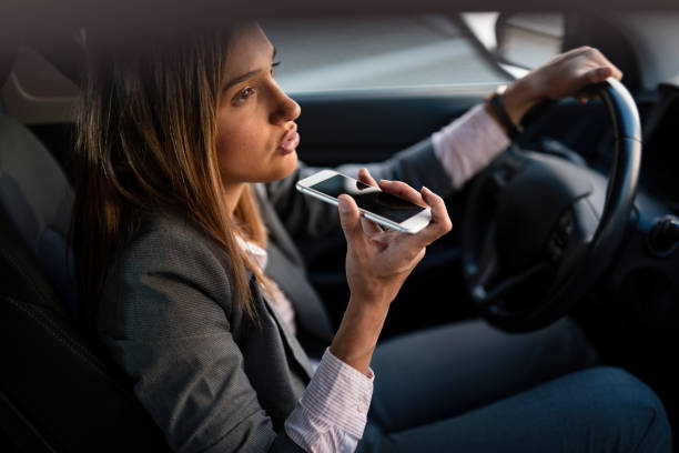 istock Businesswoman making a phone call while driving to work. 1185426243