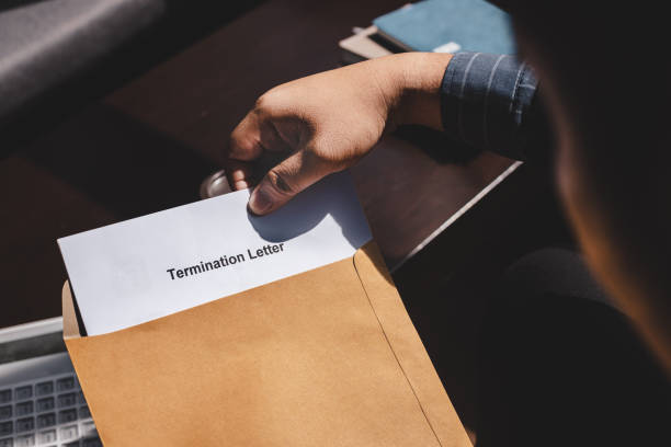 Termination of Employment and layoff concept Termination of Employment and layoff concept, Stressed businessman feeling down after received Termination of Employment Form in paper brown envelope. finishing stock pictures, royalty-free photos & images