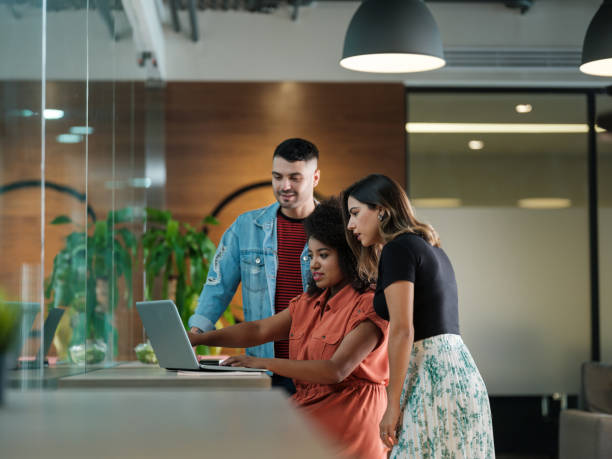 istock Young latin people looking at laptop in open space 1185430897