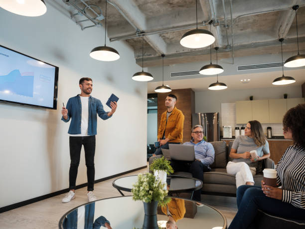 Young  latin man giving presentation in coworking space stock photo