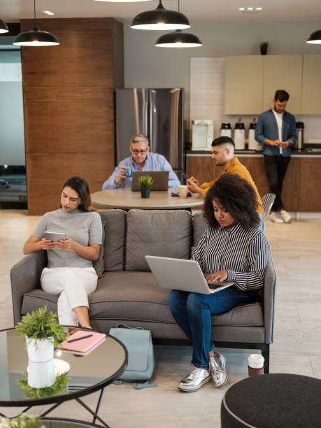 istock Latin people sitting in coworking space and using devices 1185430938