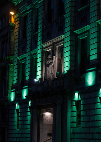 green lights illuminating the exterior of the Freemason's Hall, at night, in downtown Edinburgh, Scotland.  It is the Grand Lodge of Scotland