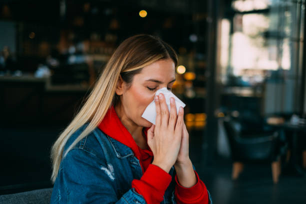 istock Sick Woman Wiping Her Nose 1185432049
