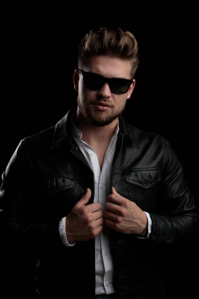 istock casual man standing and fixing his jacket with both hands 1185432166