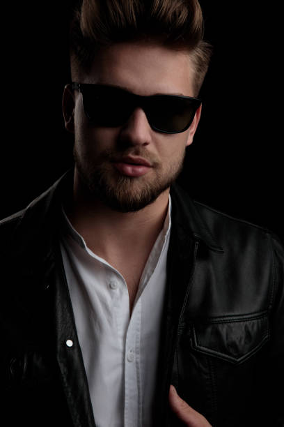 istock good looking casual man wearing sunglasses standing and adjusting  jacket 1185432195