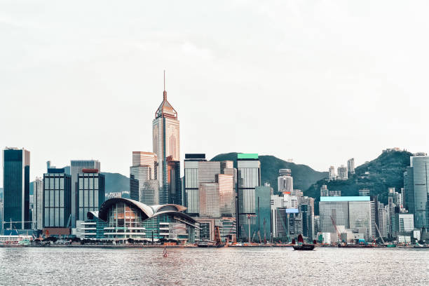 istock Small Junk and Victoria Harbor in Hong Kong 1185432466