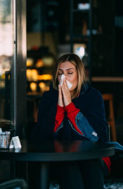 istock Sick Woman Wiping Her Nose 1185433850