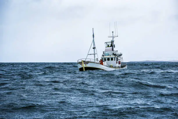 fishing boat in open cold sever ocean