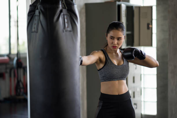 istock Strong woman practice Thai boxing in gym 1185434509