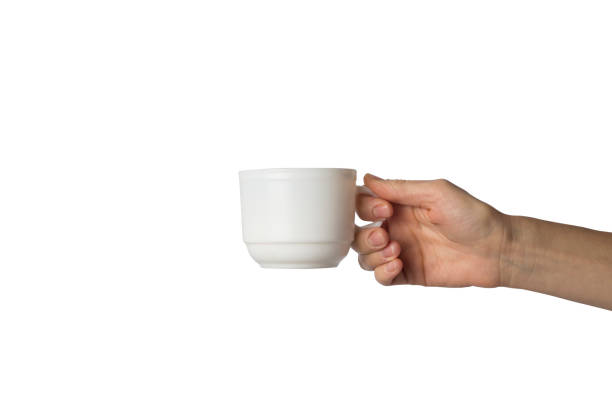 istock Female hand holding a white cup with hot coffee on a white background. Side view 1185435618