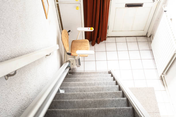 istock Automatic stair lift on staircase taking elderly people and disabled persons up and down in a house 1185439056