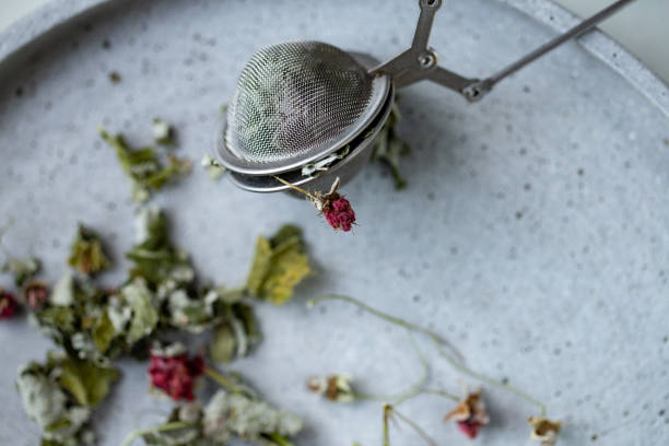 istock Herbal tea with dried raspberry and leaves on stone background with copy space 1185440348