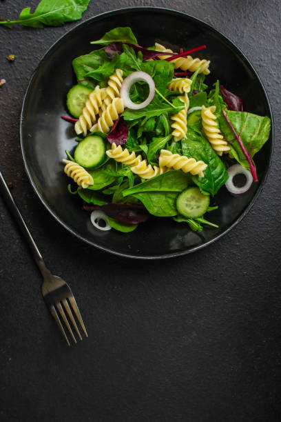 istock pasta salad Fusilli (leaves Lettuce, Spinach, Vegetables, Gemelli) Menu Concept. food background. copy space. Top view 1185440498