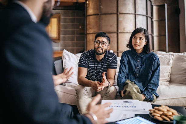 istock Young couple discussing about financial plan with financial advisor 1185441835