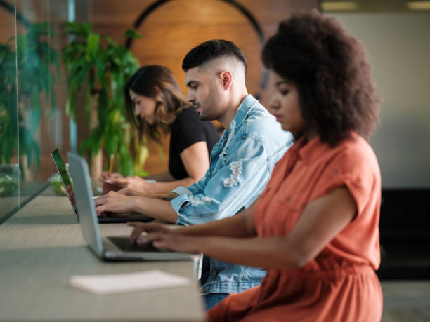 istock Young latin people sitting in coworking space and using laptop 1185442457