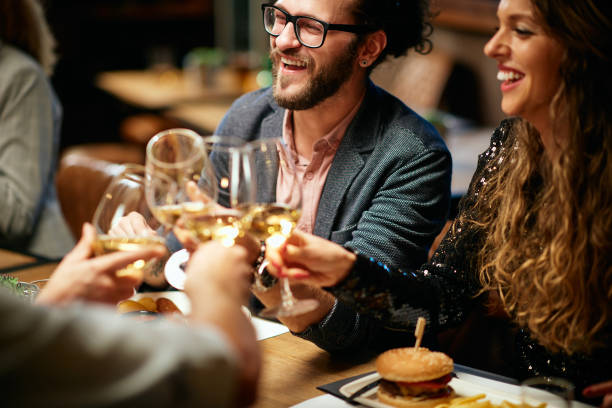 istock Friends toasting with wine while sitting in restaurant. 1185443851