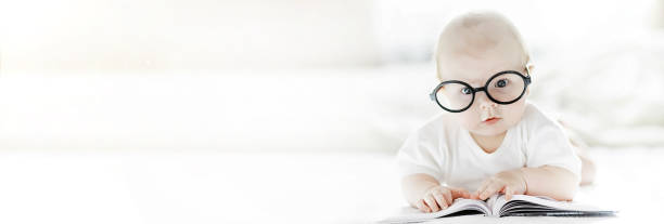istock A newborn baby is lying on a soft bed in glasses. 1185443890