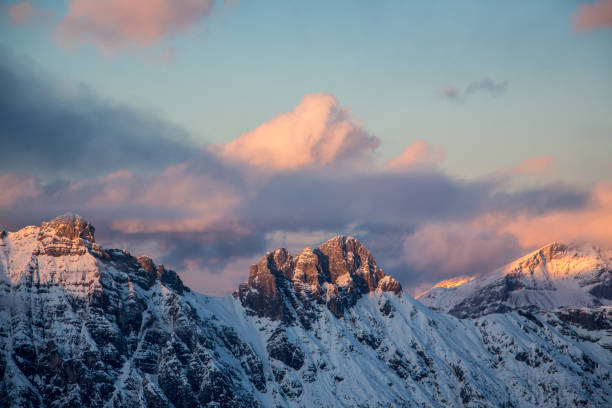 perfect sunset view of mountain in tyrol Austria saalbach-hinterglemm with a cloud shaping just like the peak of the mountain and a perfect mood and sunset light