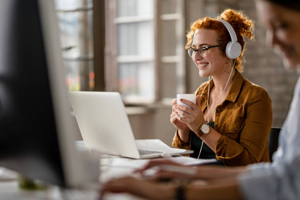 istock Happy creative businesswoman drinking coffee while reading an e-mail on laptop. 1185444198