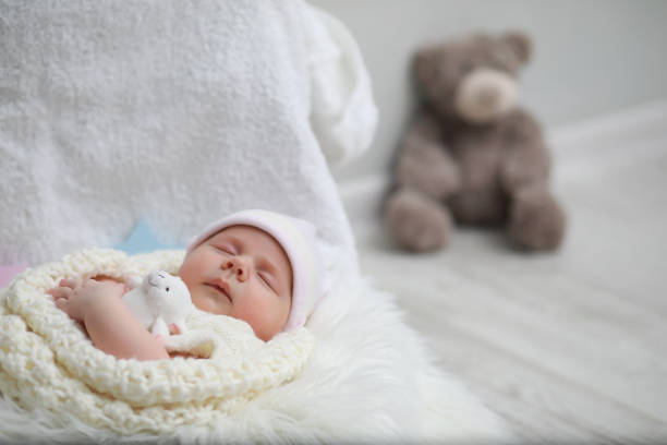 istock Baby newborn sleeping wrapped up in a blanket 1185444445