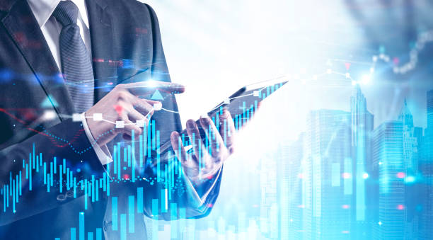 istock Businessman with tablet in city, forex charts 1185444542
