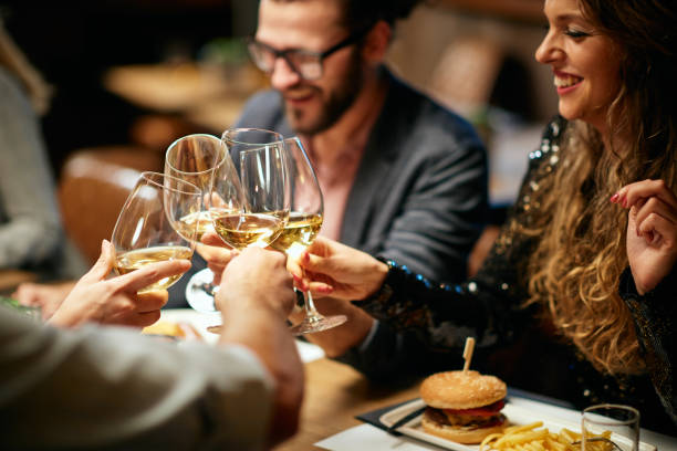 istock Friends toasting with wine while sitting in restaurant. 1185444611