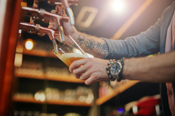 istock Barman pouring beer from keg. 1185444674