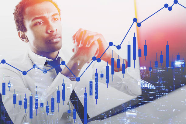 istock Serious African broker, forex charts 1185445323
