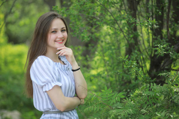 istock A girl in a spring green park 1185445455