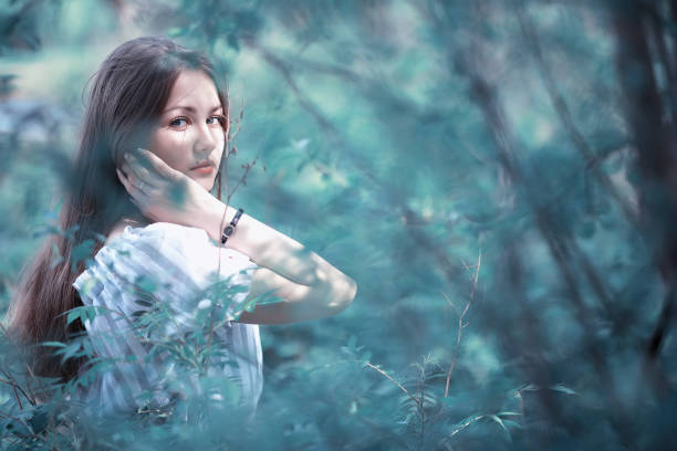 istock A girl in a spring green park 1185445512