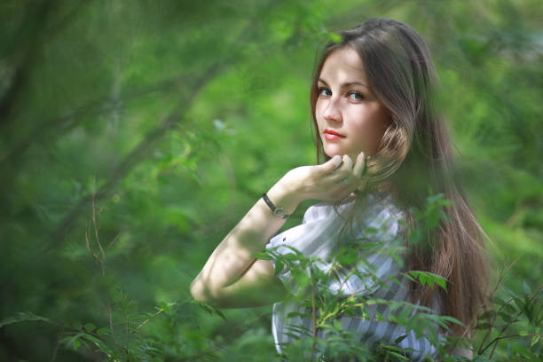 istock A girl in a spring green park 1185445533