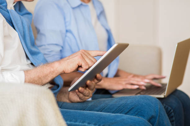 istock Modern mature couple using various gadgets, closeup 1185445649