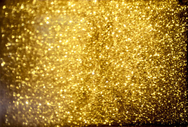 istock golden glitter bokeh lighting texture Blurred abstract background for birthday, anniversary, wedding, new year eve or Christmas 1185445823