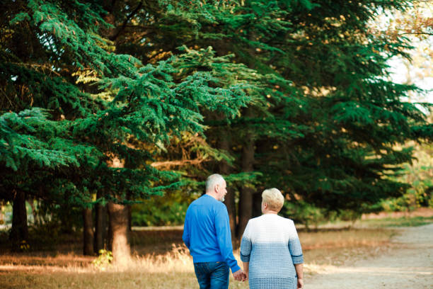 istock Pensioners walk in the park. Happy old age. 1185446022