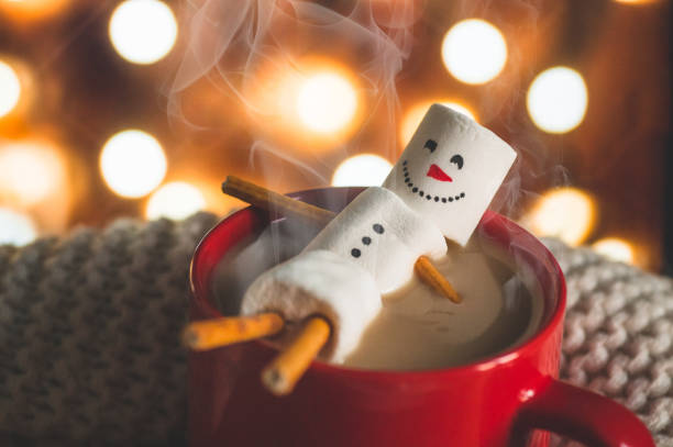istock Red mug with hot chocolate with melted marshmallow snowman 1185446138