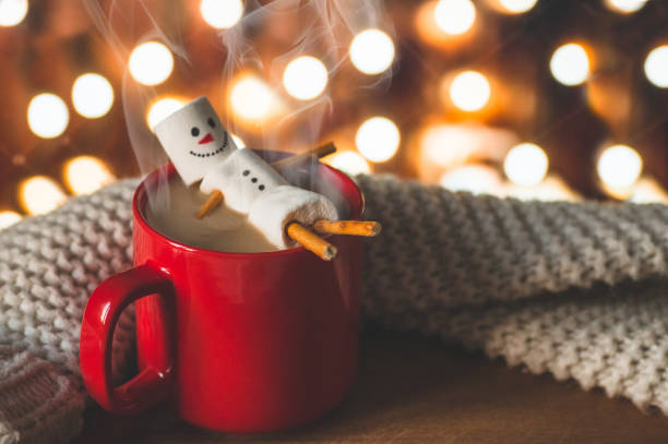 istock Red mug with hot chocolate with melted marshmallow snowman 1185446141