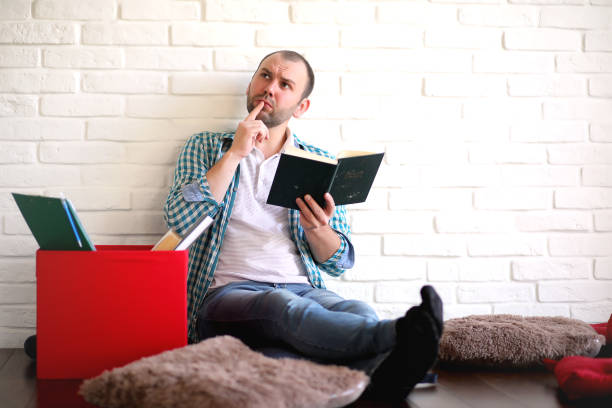istock young student in the room reading 1185446189