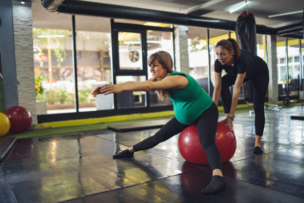 istock Pregnant woman exercises with a personal trainer 1185447897