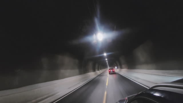 Driving through a dark car tunnel in Norway Ålesund