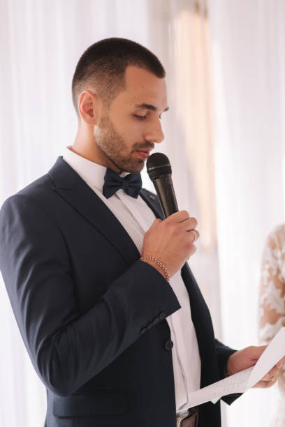 istock Handsome groom reading wedding vows and started crying. Groom have feeling of overwhelming love for bride 1185450846