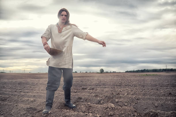 istock A young peasant sows the field with grain 1185452221