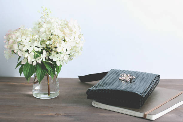 istock composition on a dark wooden background. bouquet of white hydrangeas and notepad 1185452417