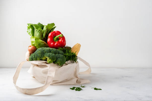 istock Grocery fabric eco bag full of different organic fresh vegetables on a light background. Zero waste purchases concept. Clean eating. Healthy diet food. 1185452676