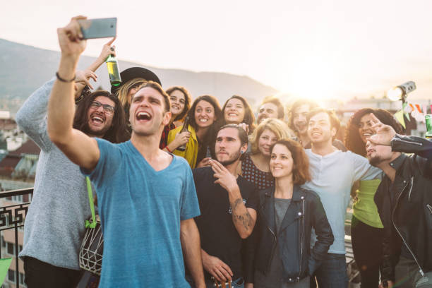 istock Friends taking selfie on rooftop party 1185454570