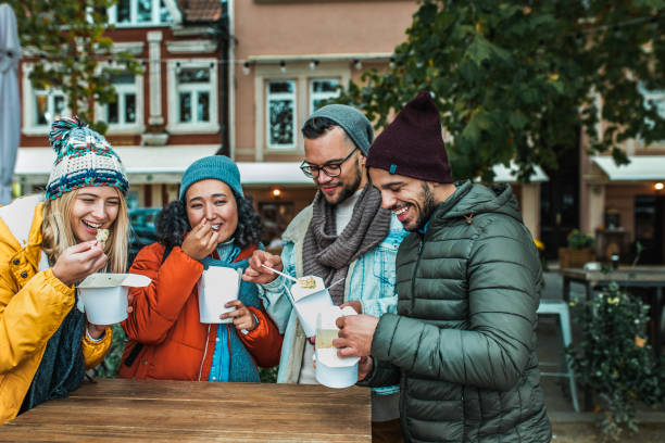 istock Friends eating pasta outdoors 1185455110