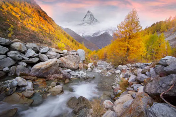 stormy clear mountain river among the great Alps mountains in Switzerland near the town of Zermatt near Matterhorn overlooking the famous peak of Europe