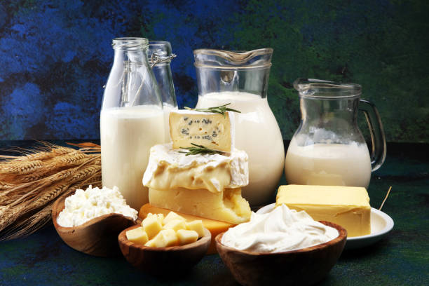 istock Different  healthy dairy products on rustic background with milk, cheese, butter and cottage 1185455979