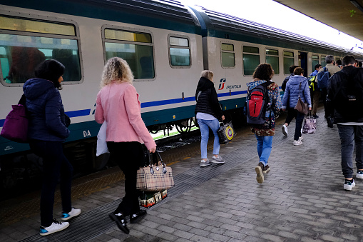 Passengers walk on a platform after a commuter train arrived at central railway station in Siena, Italy on Oct. 28, 2019