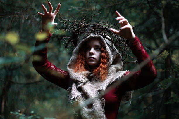 istock The red-haired witch holds a ritual with a crystal ball 1185456495