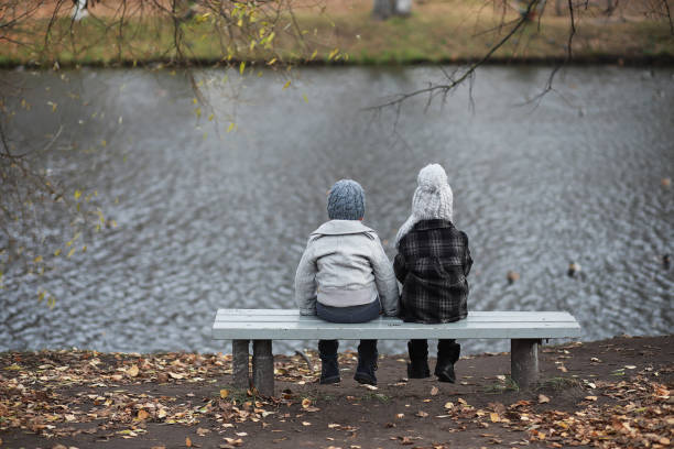 istock Children walk in the autumn park 1185457481
